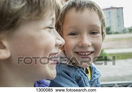 Stock Photography - Two boys smiling, close-up. Fotosearch