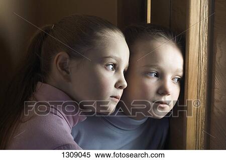 Two girls eavesdropping on door, close-up View Large Photo Image Stock Photography - Two girls eavesdropping on door, close-up. Fotosearch