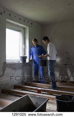 Two men painting the wall View Large Photo Image Stock Photography - Two men painting the wall. Fotosearch