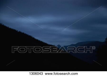 Stock Image - View of mountains at twilight. Fotosearch