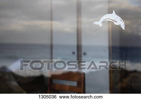View of rough sea through window with dolphin decal on it View Large Photo Image Stock Photograph - View of rough sea through window with dolphin decal on it. Fotosearch