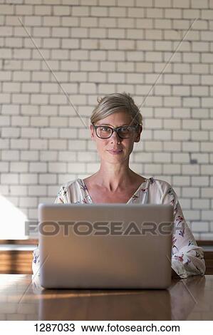 Woman using laptop, portrait View Large Photo Image Stock Image - Woman using laptop, portrait. Fotosearch