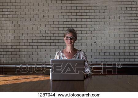 Woman with laptop, portrait View Large Photo Image Picture - Woman with laptop, portrait. Fotosearch