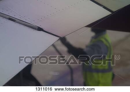 Stock Photograph - Worker standing at construction site. Fotosearch