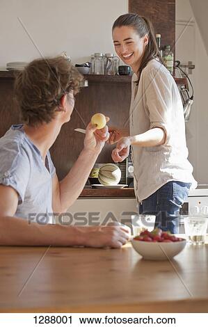 Young couple in kitchen preparing breakfast View Large Photo Image Stock Image - Young couple in kitchen preparing breakfast. Fotosearch