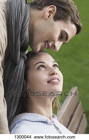 Picture - Young couple looking at each other. Fotosearch