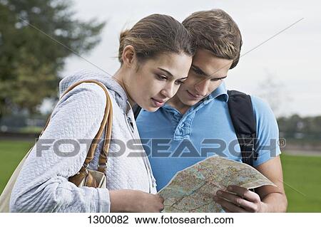 Young couple looking at map View Large Photo Image Stock Image - Young couple looking at map. Fotosearch