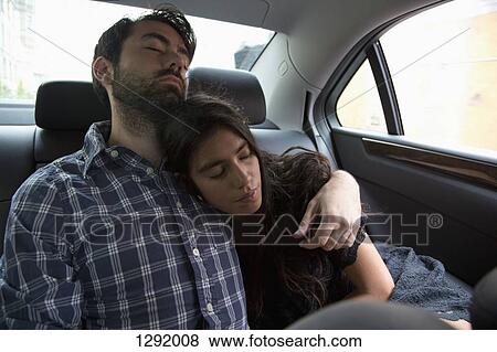 Stock Photo - Young couple relaxing in car. Fotosearch
