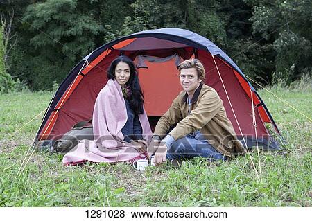Young couple sitting near dome tent, portrait View Large Photo Image Stock Photo - Young couple sitting near dome tent, portrait. Fotosearch