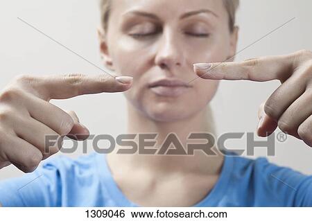 Stock Photograph - Young woman doing yoga, close-up. Fotosearch