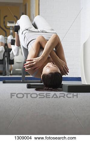 Young woman exercising in gym View Large Photo Image Picture - Young woman exercising in gym. Fotosearch