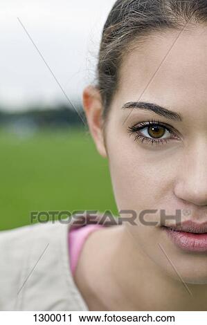 Stock Image - Young woman looking at camera, close-up. Fotosearch