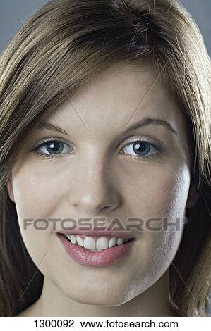 Young woman looking at camera, close-up View Large Photo Image Stock Image - Young woman looking at camera, close-up. Fotosearch