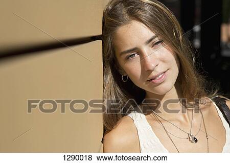 Young woman looking at camera, close-up View Large Photo Image Stock Photo - Young woman looking at camera, close-up. Fotosearch