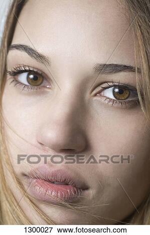 Young woman looking at camera, close-up View Large Photo Image Stock Photo - Young woman looking at camera, close-up. Fotosearch