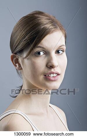 Young woman looking at camera, close-up View Large Photo Image Stock Photo - Young woman looking at camera, close-up. Fotosearch
