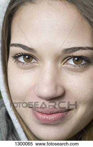 Young woman looking at camera, close-up View Large Photo Image Stock Photography - Young woman looking at camera, close-up. Fotosearch