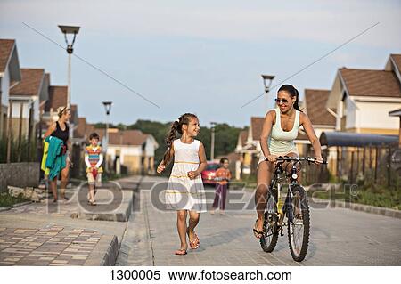 Young woman riding bicycle View Large Photo Image Stock Photography - Young woman riding bicycle. Fotosearch