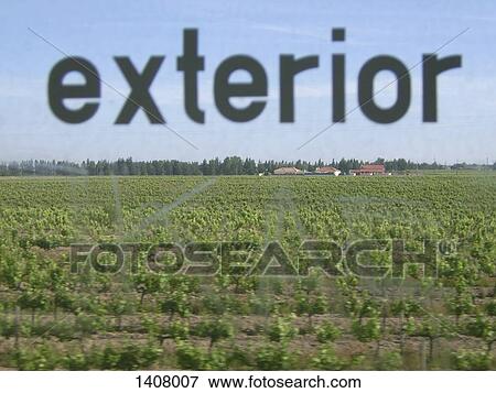 Stock Photo - Agricultural field seen through glass window with text. Fotosearch