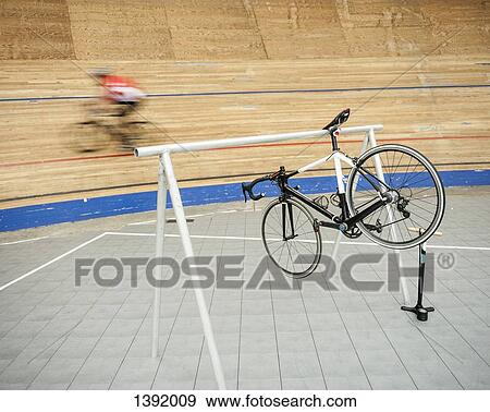 Bicycle hanging on rack at sports track View Large Photo Image Stock Photo - Bicycle hanging on rack at sports track. Fotosearch