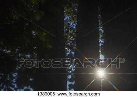 Bright sun shining on silhouette fence at sunset View Large Photo Image Stock Photography - Bright sun shining on silhouette fence at sunset. Fotosearch