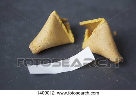Stock Image - Broken fortune cookie on table. Fotosearch
