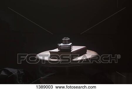 Camera and book on table against black background View Large Photo Image Stock Image - Camera and book on table against black background. Fotosearch