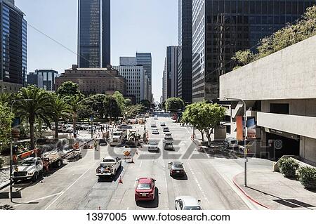 Cars on city street leading towards skyscrapers View Large Photo Image Stock Photography - Cars on city street leading towards skyscrapers. Fotosearch