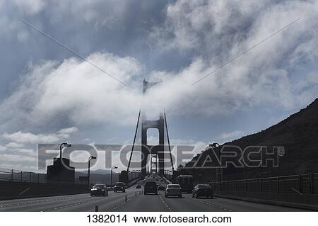 Cars on Golden Gate Bridge against cloudy sky View Large Photo Image Picture - Cars on Golden Gate Bridge against cloudy sky. Fotosearch
