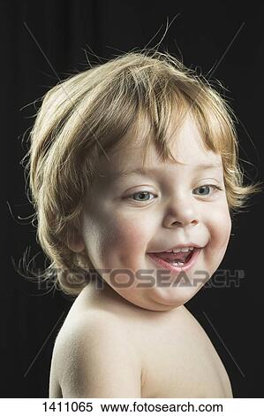Cheerful boy against black background View Large Photo Image Stock Photography - Cheerful boy against black background. Fotosearch