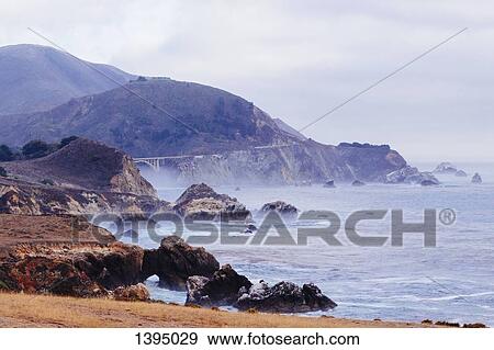 Cliff by sea against sky View Large Photo Image Stock Photo - Cliff by sea against sky. Fotosearch