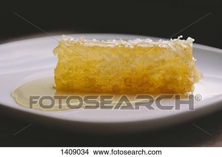 Picture - Close-up of honeycomb in plate on table. Fotosearch