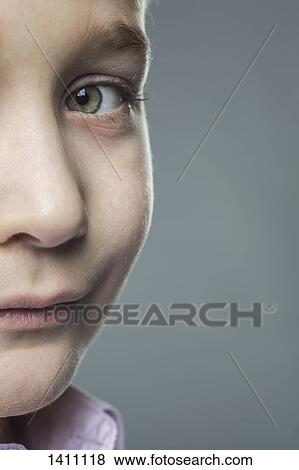 Stock Photo - Close-up of portrait of boy against gray background. Fotosearch
