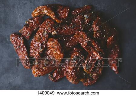 Stock Photo - Close-up of sun dried tomatoes on table. Fotosearch