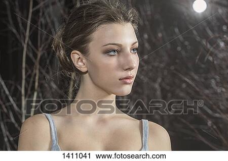 Stock Image - Close-up of thoughtful woman looking away. Fotosearch