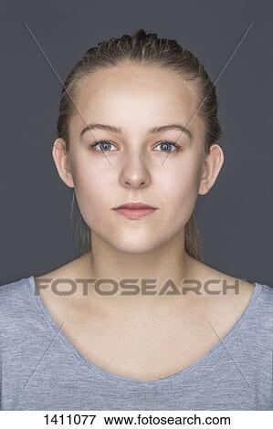 Close-up portrait of beautiful teenage girl against gray background View Large Photo Image Stock Photo - Close-up portrait of beautiful teenage girl against gray background. Fotosearch