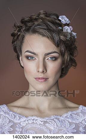 Picture - Close-up portrait of beautiful young woman against colored background. Fotosearch