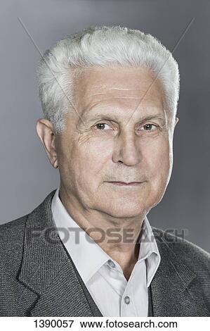 Stock Photo - Close-up portrait of confident senior man over gray background. Fotosearch