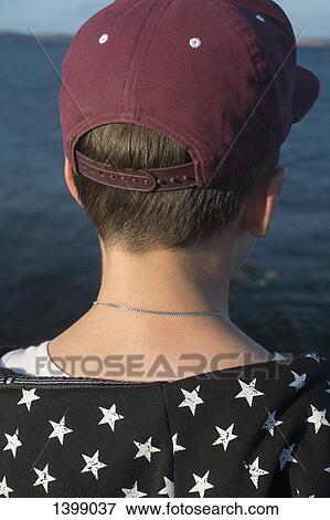 Close-up rear view of boy against lake View Large Photo Image Stock Photo - Close-up rear view of boy against lake. Fotosearch