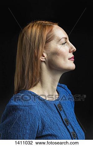 Confident mature woman against black background View Large Photo Image Stock Image - Confident mature woman against black background. Fotosearch