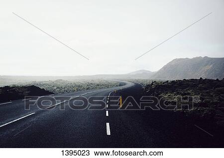 Country road passing by mountain against clear sky View Large Photo Image Stock Image - Country road passing by mountain against clear sky. Fotosearch