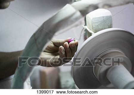 Cropped image of craftsperson polishing gemstone View Large Photo Image Stock Photo - Cropped image of craftsperson polishing gemstone. Fotosearch