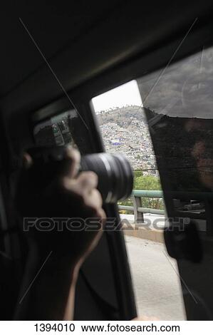 Cropped image of hand photographing mountain from bus window View Large Photo Image Stock Image - Cropped image of hand photographing mountain from bus window. Fotosearch