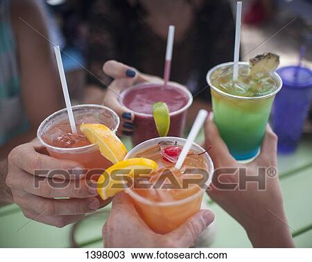 Cropped image of people holding drinks outdoors View Large Photo Image Stock Image - Cropped image of people holding drinks outdoors. Fotosearch