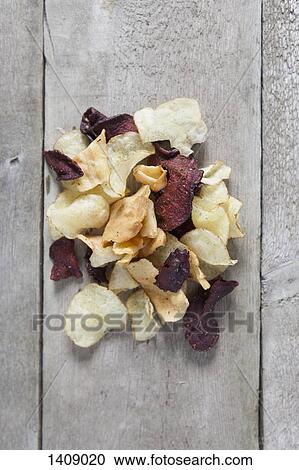 Directly above shot of potato and beetroot chips on wooden table View Large Photo Image Stock Image - Directly above shot of potato and beetroot chips on wooden table. Fotosearch