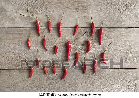 Directly above shot of red chili peppers on wooden table View Large Photo Image Stock Photo - Directly above shot of red chili peppers on wooden table. Fotosearch