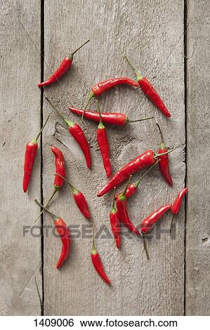 Directly above shot of red chili peppers on wooden table View Large Photo Image Stock Photograph - Directly above shot of red chili peppers on wooden table. Fotosearch