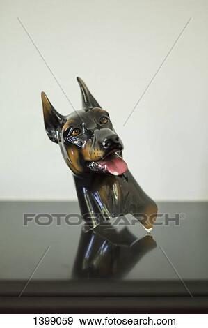 Dog figurine on table against white background View Large Photo Image Stock Photo - Dog figurine on table against white background. Fotosearch