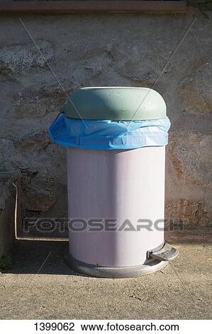 Stock Image - Dustbin against wall. Fotosearch