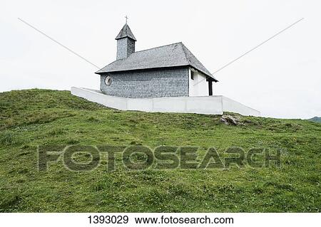Exterior of church on grassy field View Large Photo Image Stock Photo - Exterior of church on grassy field. Fotosearch
